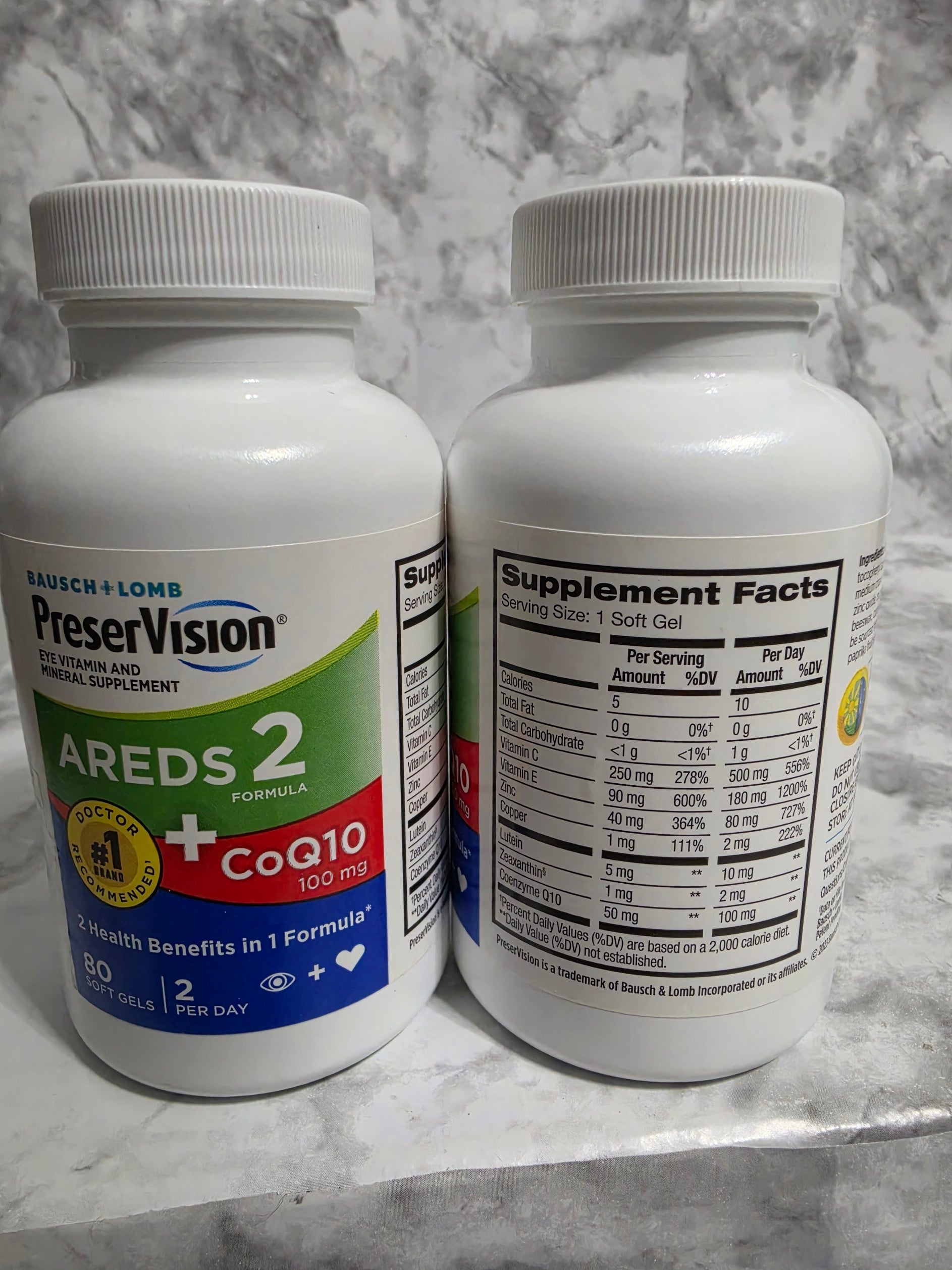 Two supplement bottles labeled 'Arex 2' and 'Preservision' on a marble surface.