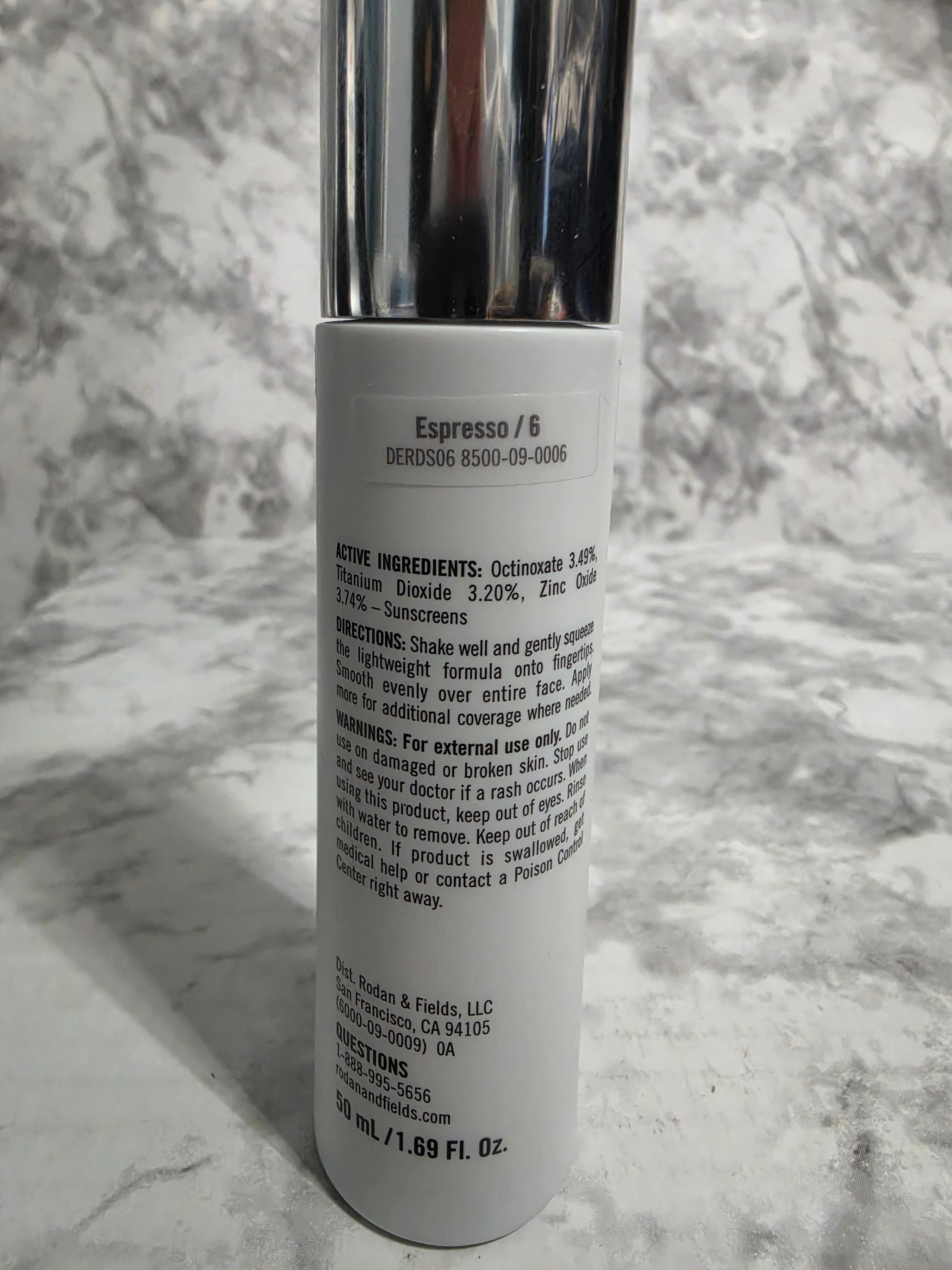 Cosmetic tube with label on a marble surface