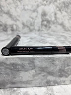 Actual Mary Kay Lash Love Lengthening Mascara tubes on gray marble, showing front branding and a bottom label