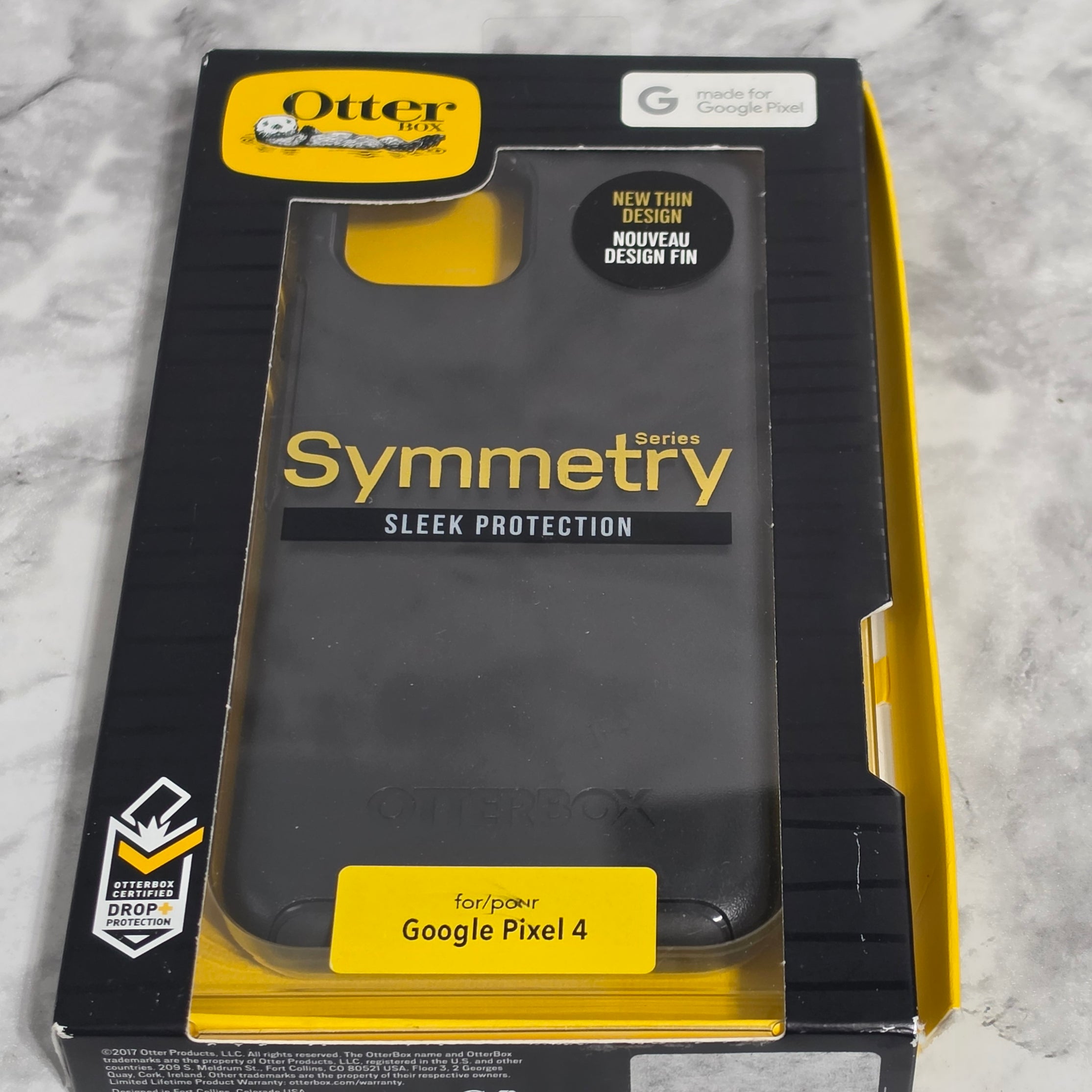 OtterBox Symmetry Series Case for Google Pixel 4 – real product retail packaging showing New Thin Design and Drop+ Protection badge