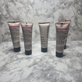 Mary Kay TimeWise Luminous-Wear Liquid Foundation tubes showing multiple shades including Ivory 3, Ivory 7, and Bronze variants on marble surface