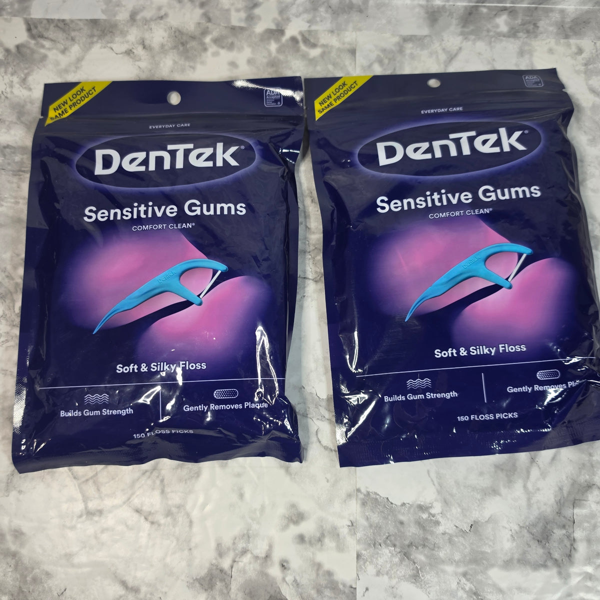 Two sealed DenTek Sensitive Gums Comfort Clean 150-count floss pick bags
