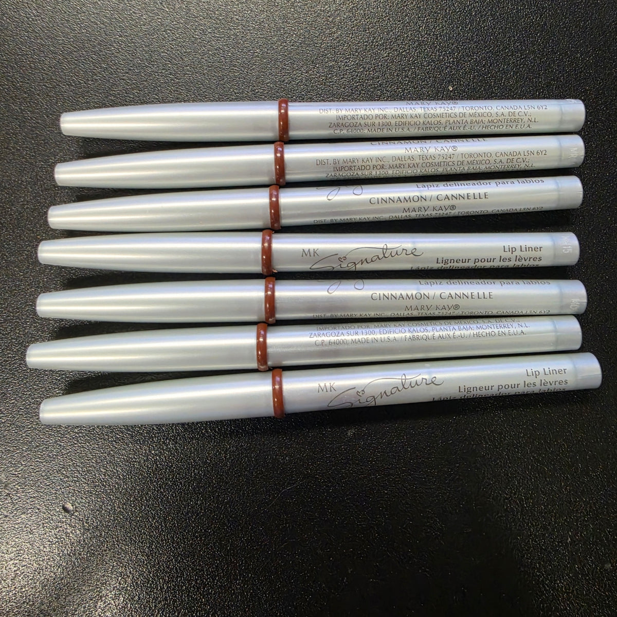 Mary Kay Signature Cinnamon lip liners with silver barrels, front view.
