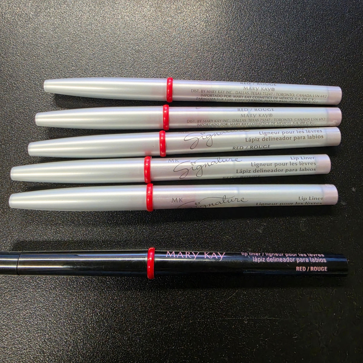 Mary Kay Red lip liners in black and silver barrel editions.