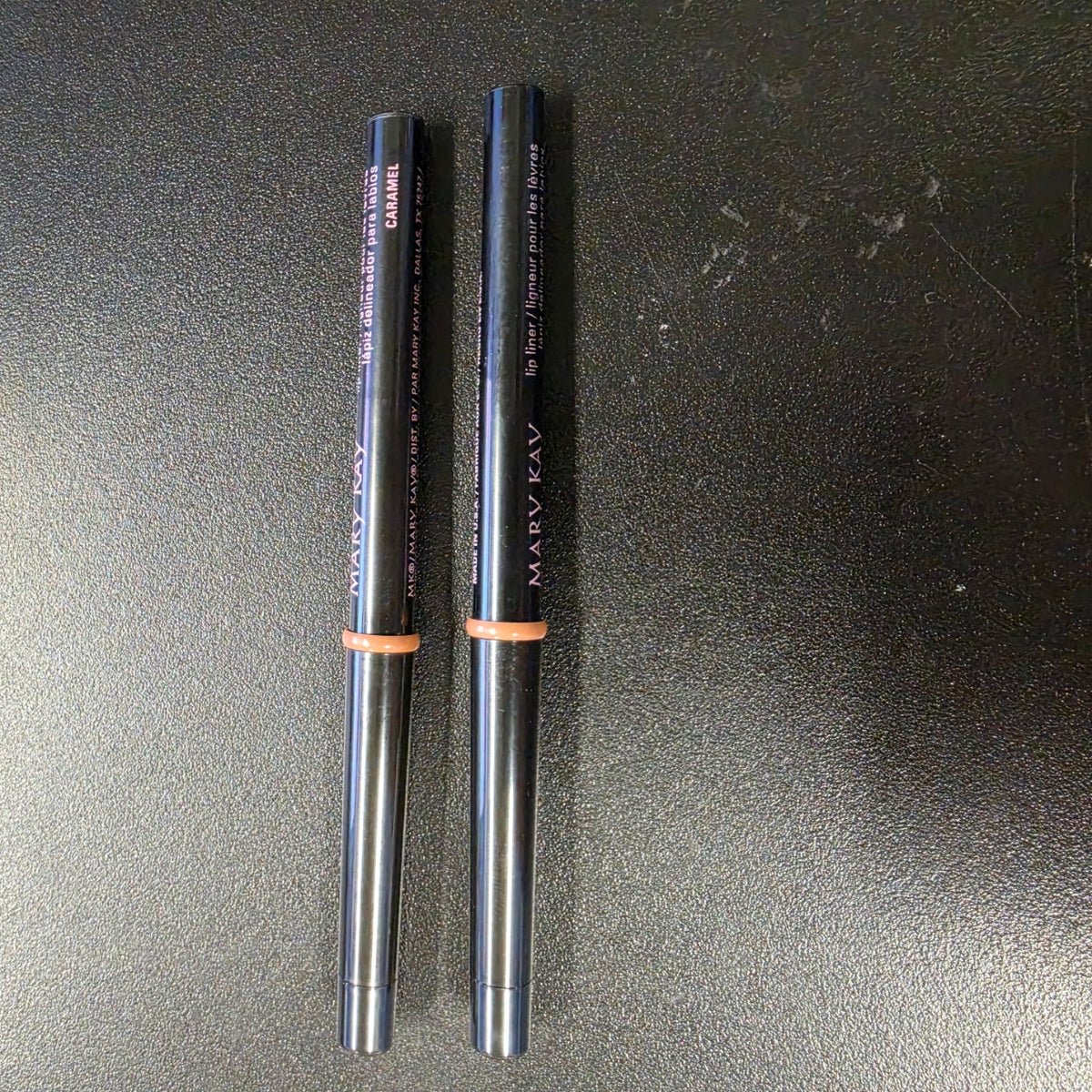 Mary Kay Caramel lip liners with black barrels, front view.