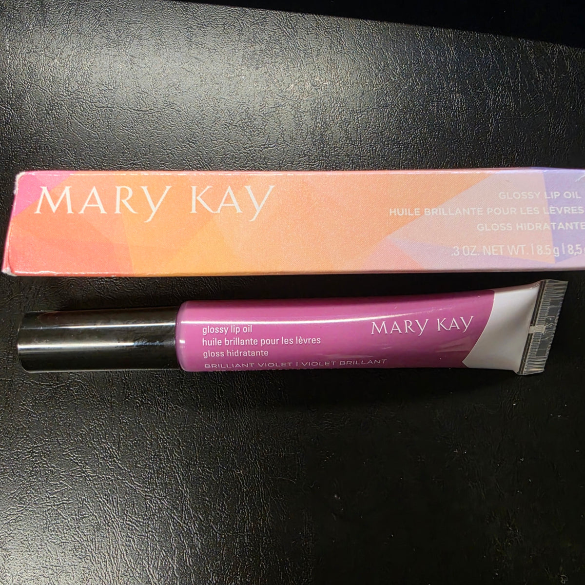 Actual stocked Mary Kay Glossy Lip Oil tube and box in Brilliant Violet