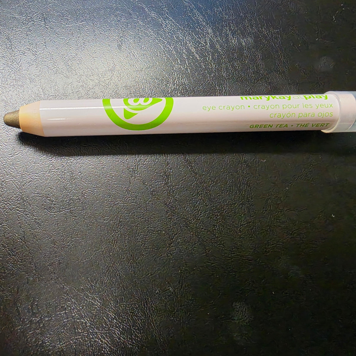 Mary Kay At Play Green Tea eye crayon with its olive-green tip exposed.