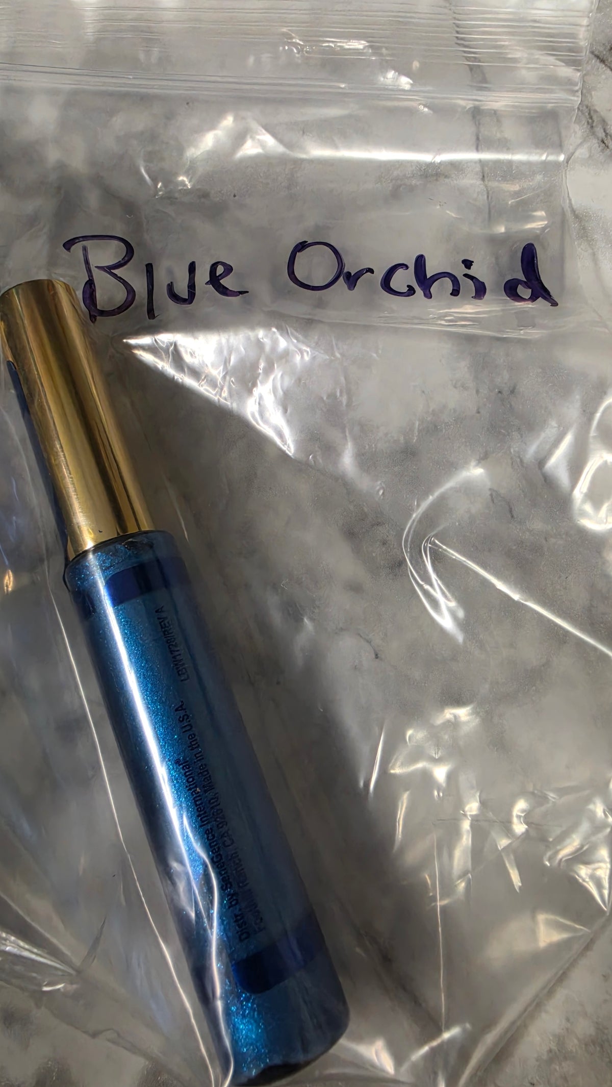 Blue Orchid LipSense gloss tube in its labeled bag