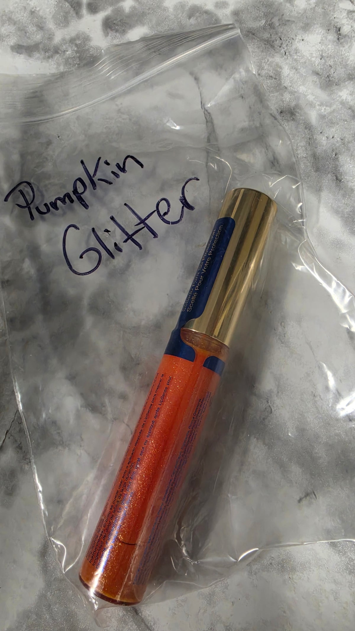 Pumpkin Glitter LipSense gloss tube in its labeled bag
