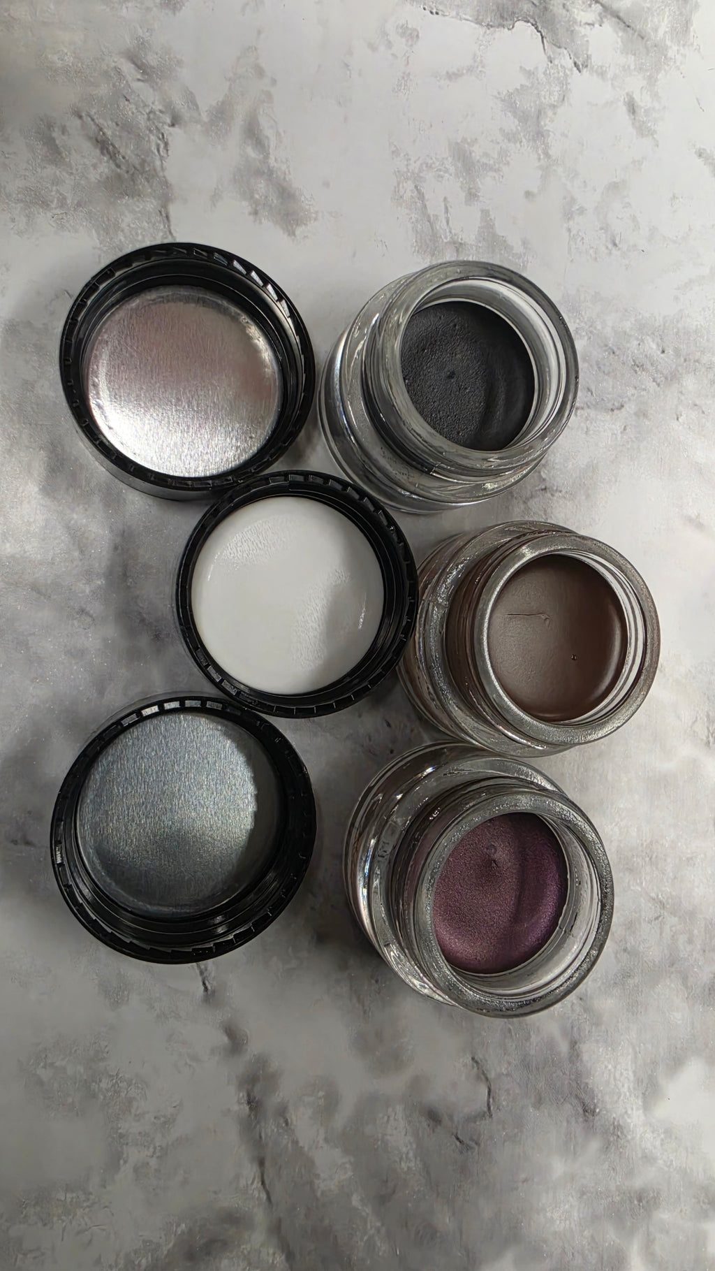 Actual stocked Mary Kay Gel Eyeliner jars opened showing gel texture and brush applicators
