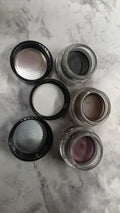 Actual stocked Mary Kay Gel Eyeliner jars opened showing gel texture and brush applicators