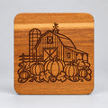 Square wood coaster with a barn, silo and pumpkins engraving