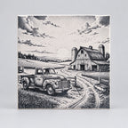 A square ceramic tile featuring a black and white stippled illustration of a rural farm scene with a vintage pickup truck, barn, silos, fields, and cloudy sky.