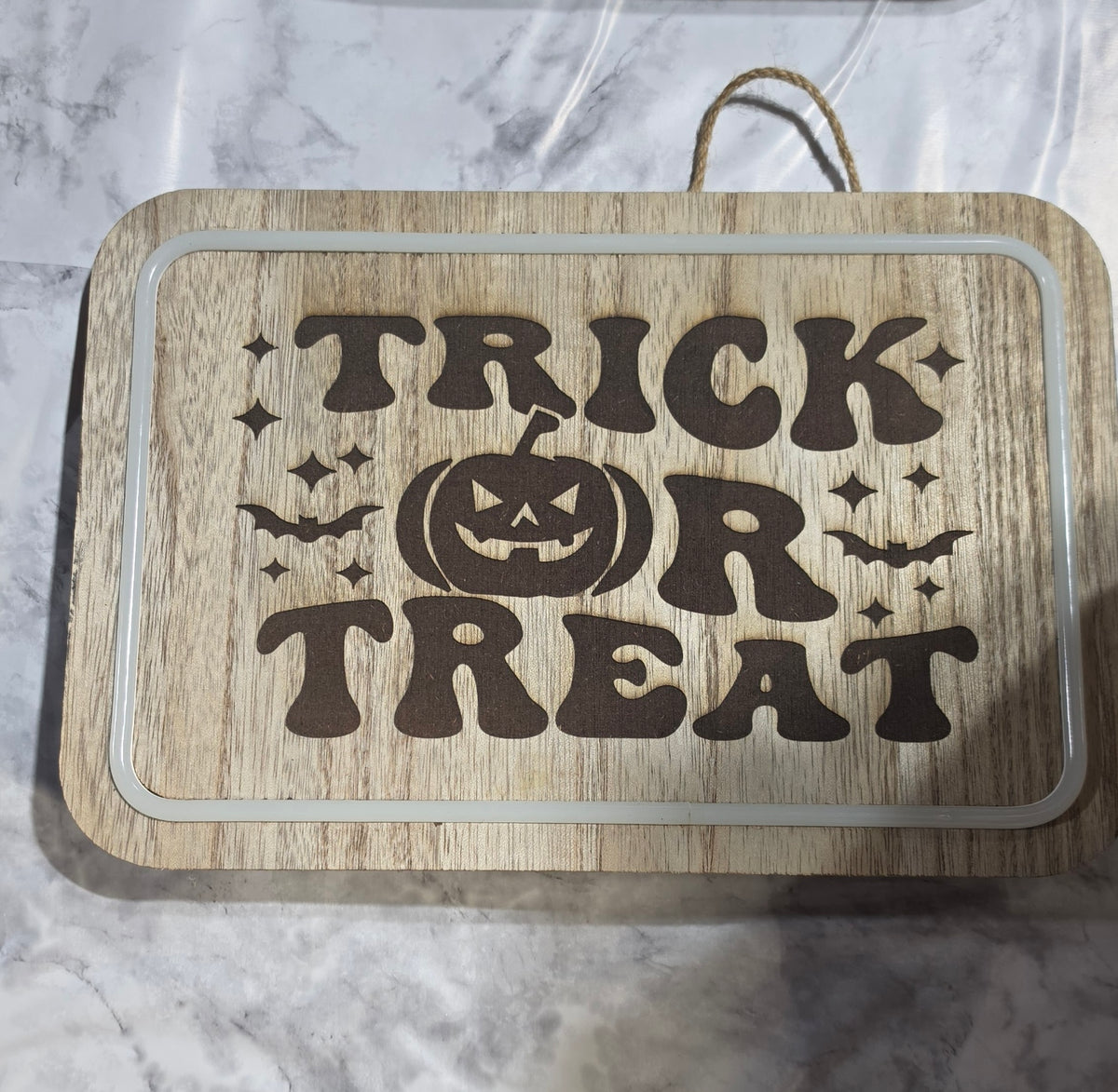 Actual Trick or Treat pumpkin laser-engraved LED hanging plaque.