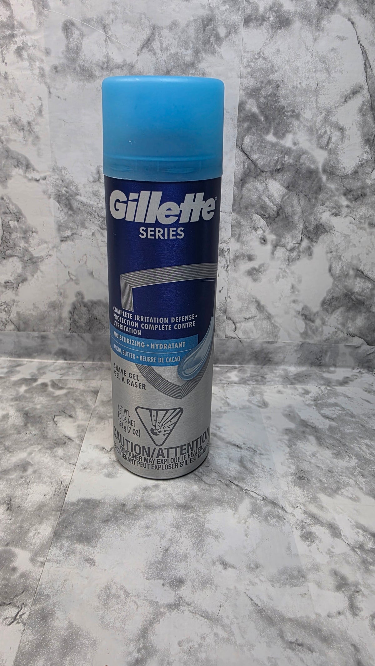 Front of a Gillette Series Moisturizing shave gel can with a blue cap, 7 oz