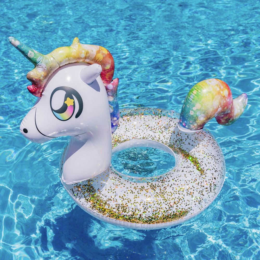 PoolCandy Glitter Unicorn pool tube floating in blue swimming-pool water