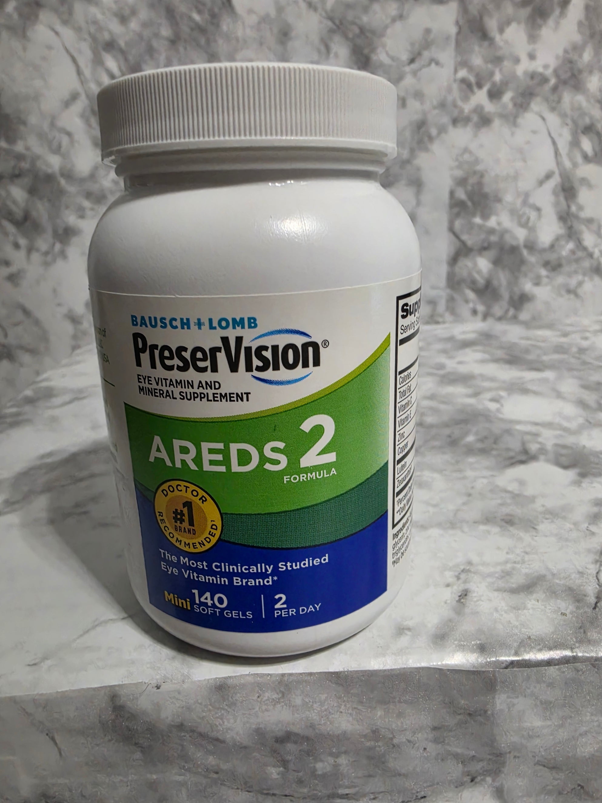 PreserVision AREDS 2 supplement bottle on a marble surface