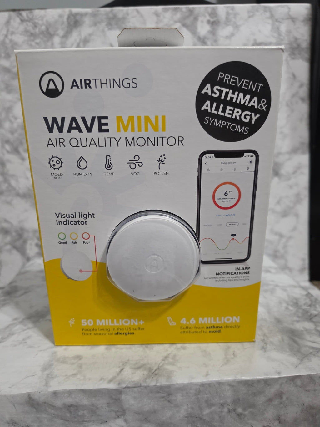 Airthings Wave Mini air quality monitor packaging on a marble surface