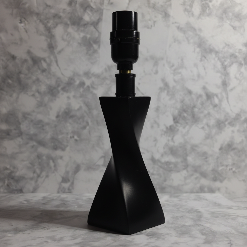 Architectural silhouette of matte black twisted lamp base reflecting soft evening light against neutral background
