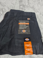 Black cargo pants with Dickies labels on a light gray background