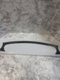 Black handle on a white surface against a marble-patterned wall