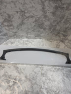Black handle on a white surface against a marble-patterned wall