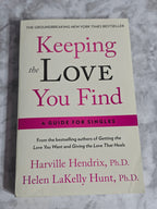 Book titled 'Keeping the Love You Find' by Harville Hendrix and Helen LaKelly Hunt on a marble surface.