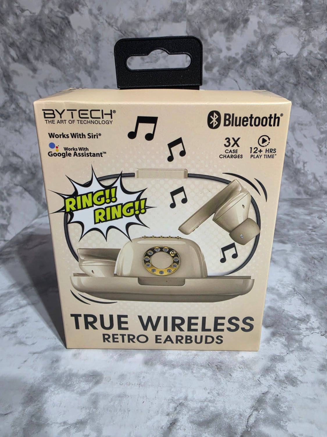 Box of true wireless retro earbuds with a vintage phone design on a gray surface