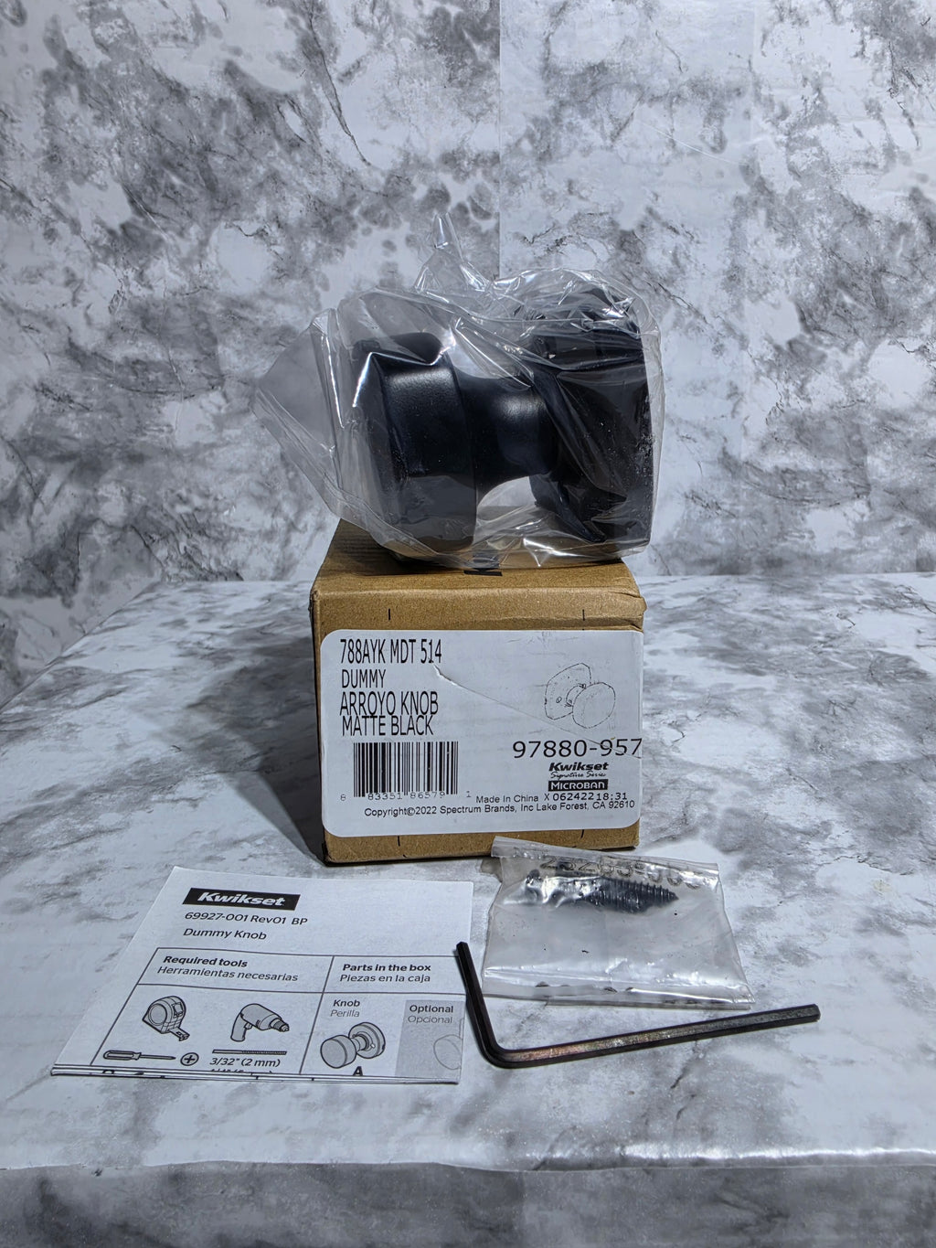 Box with a black component on a gray marble surface