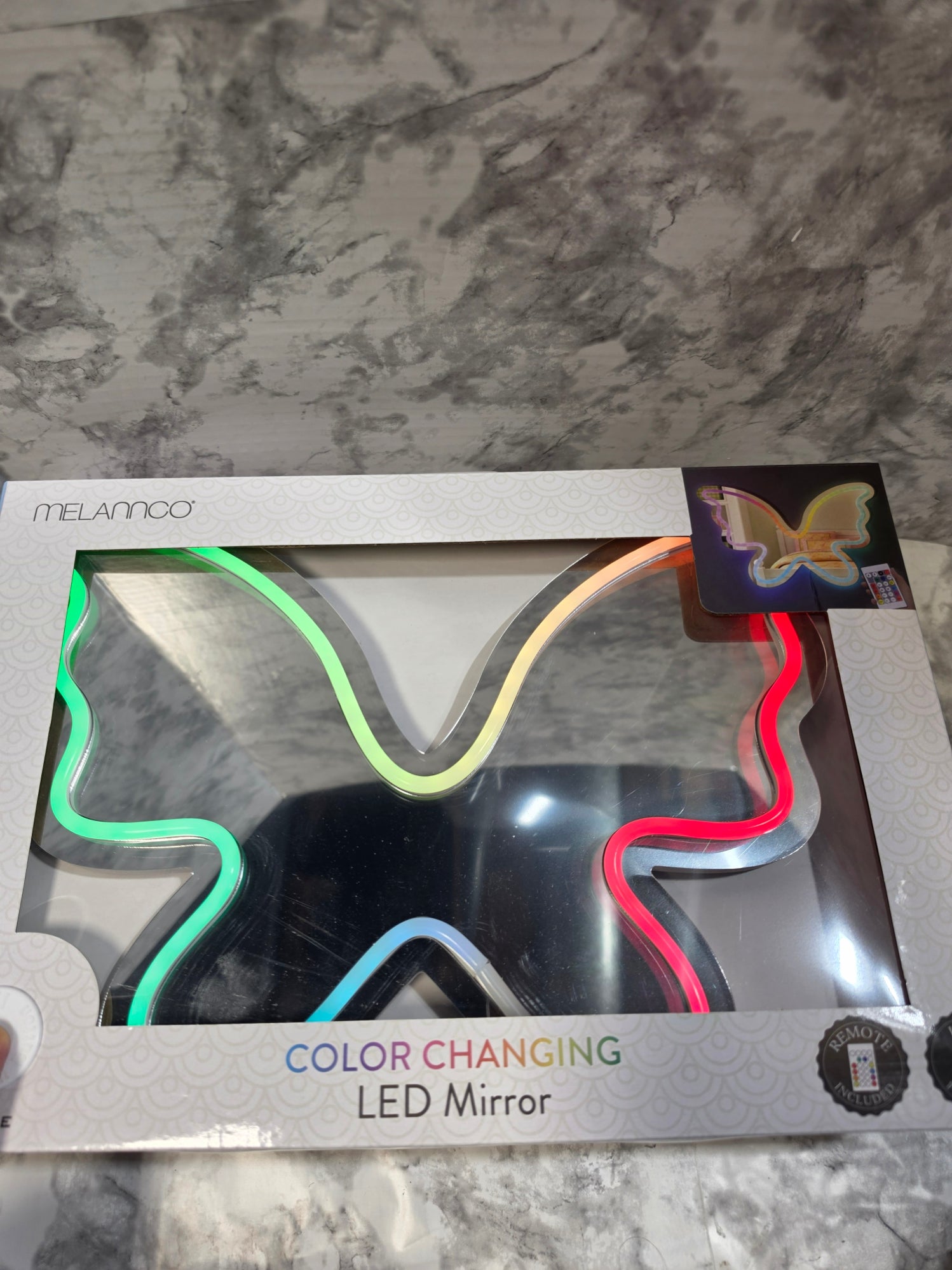 Color-changing LED mirror packaging on a marble surface