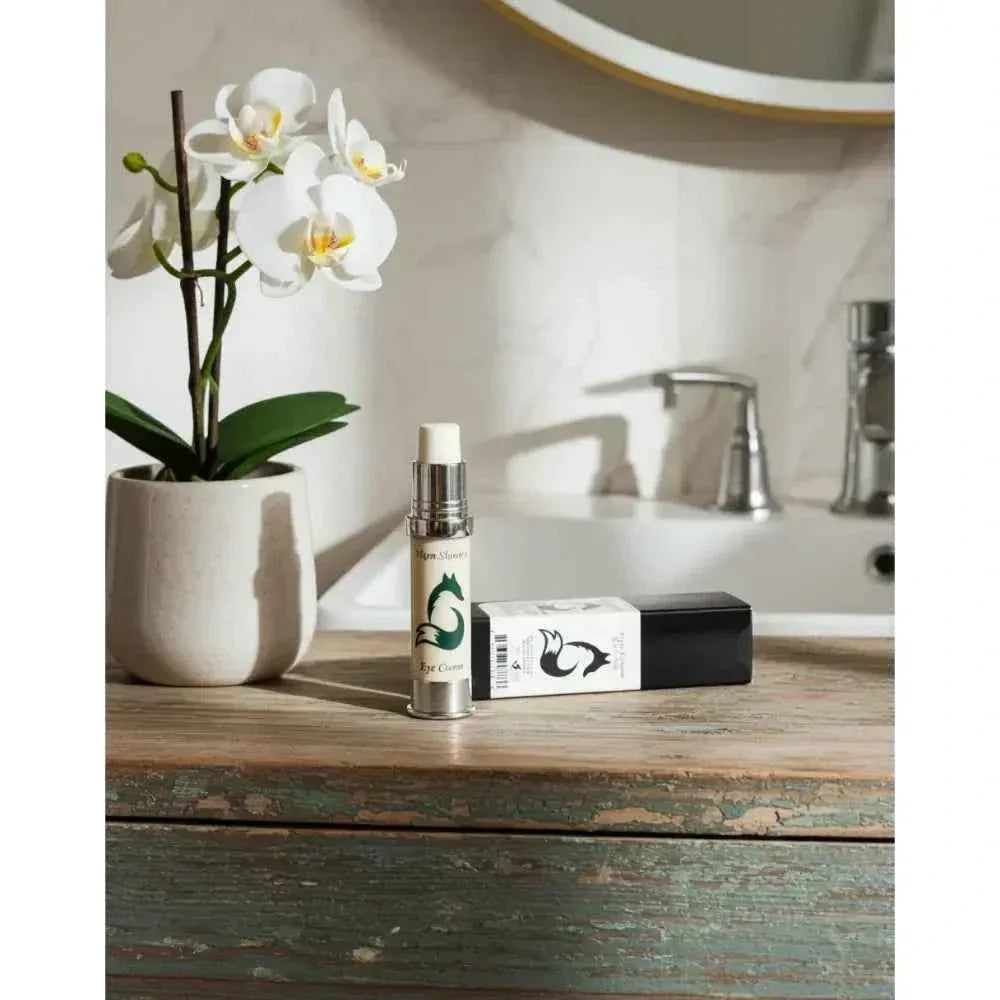 Vixen Botanical Eye Cream dispenser and carton on a wooden bathroom counter
