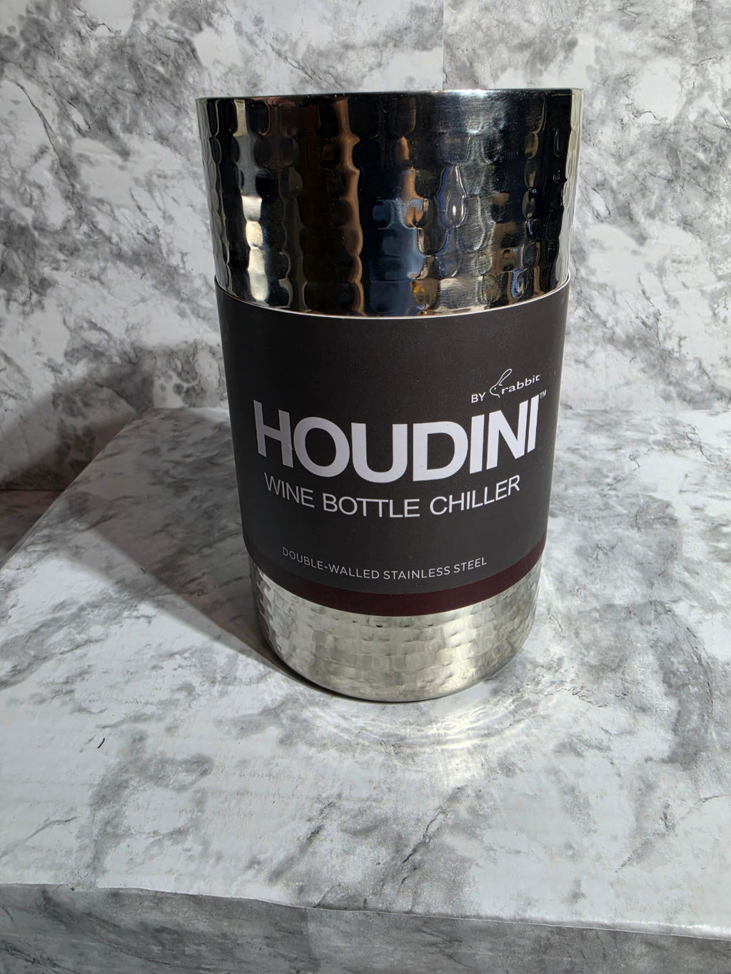 Houdini wine bottle chiller on a marble surface