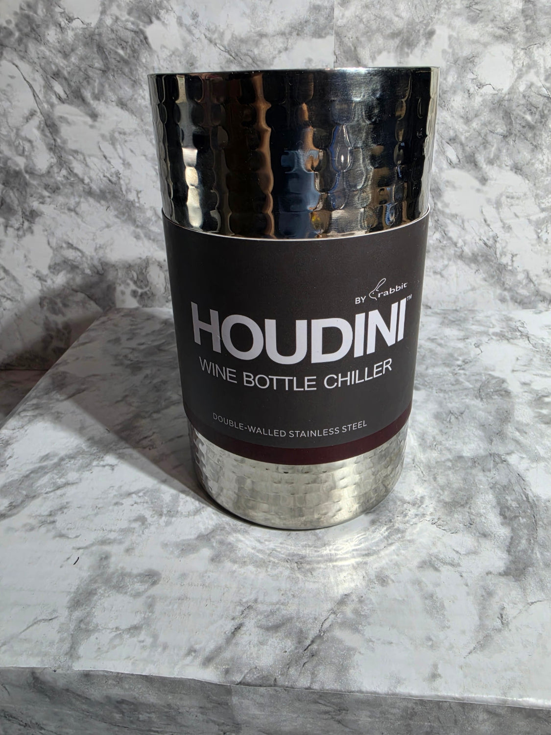 Houdini wine bottle chiller on a marble surface