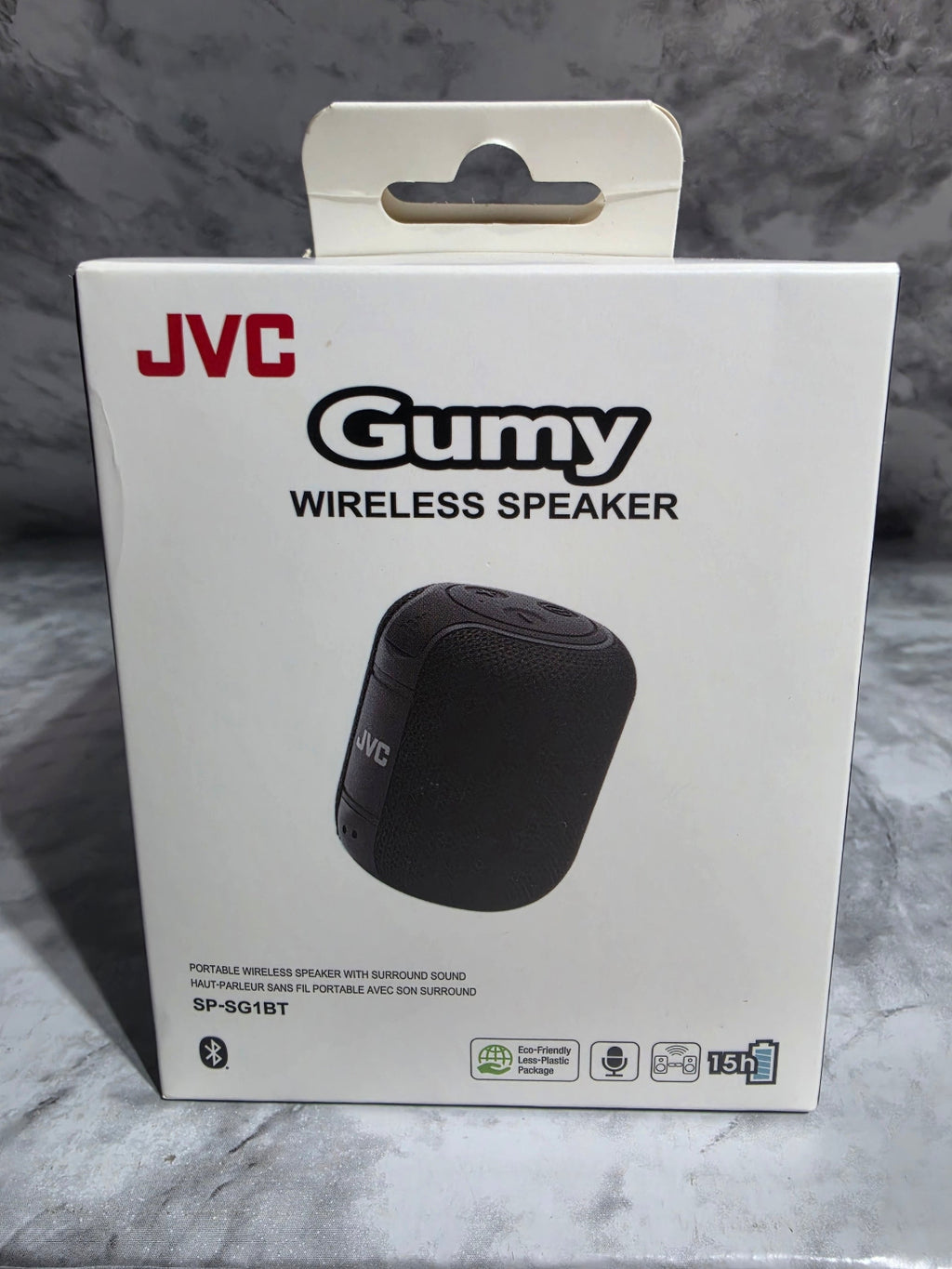JVC GUMY wireless speaker packaging on a gray marble surface