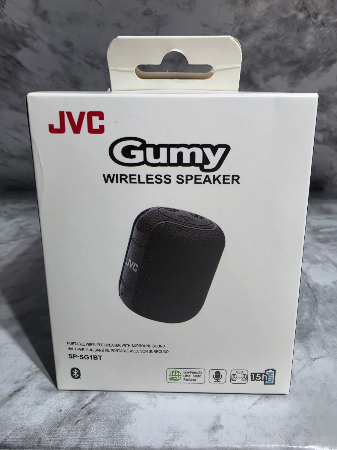 JVC GUMY wireless speaker packaging on a gray marble surface