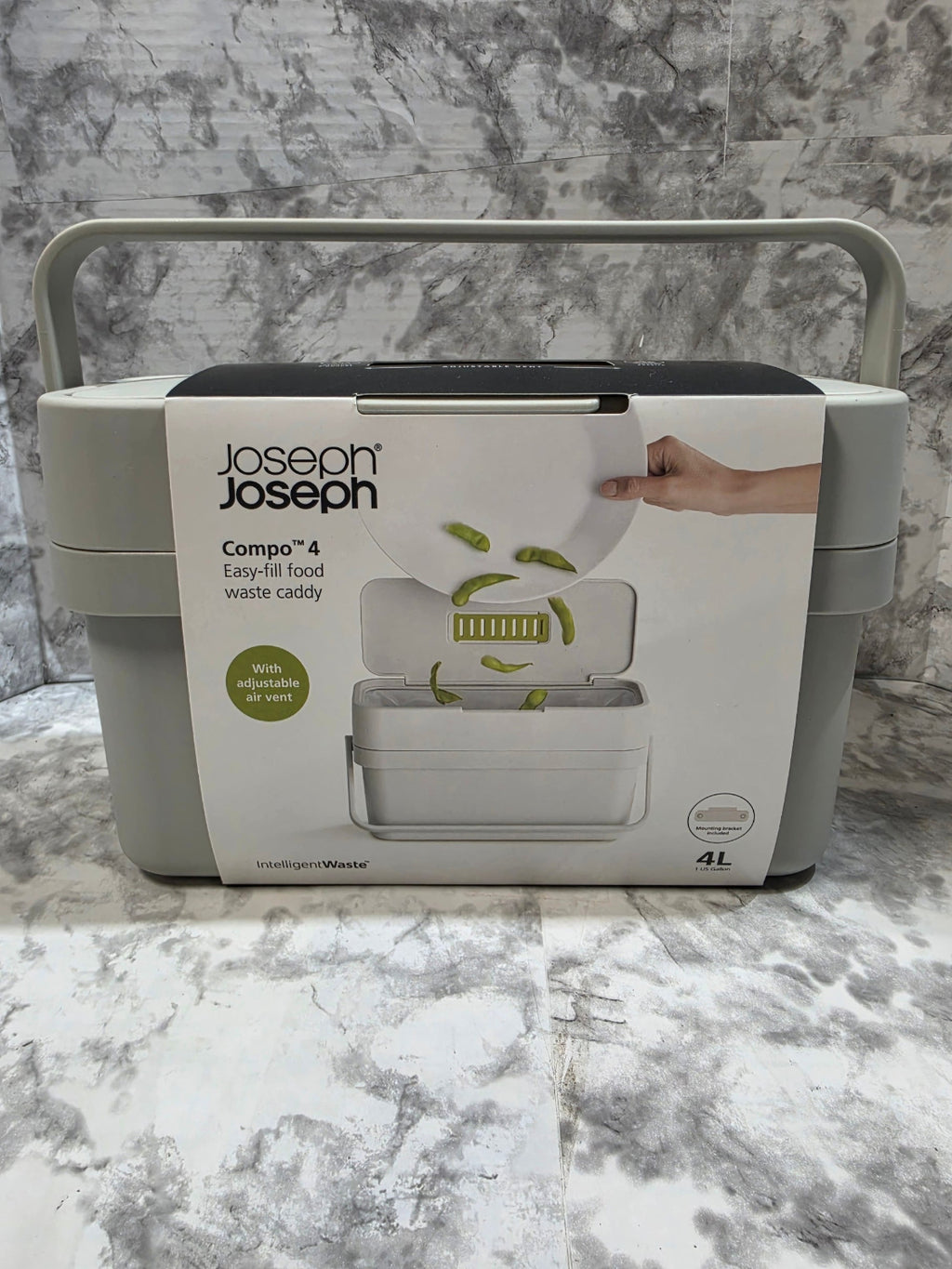 Joseph Joseph compost bin on a marble countertop