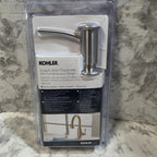 Kohler soap dispenser in packaging on a marble surface