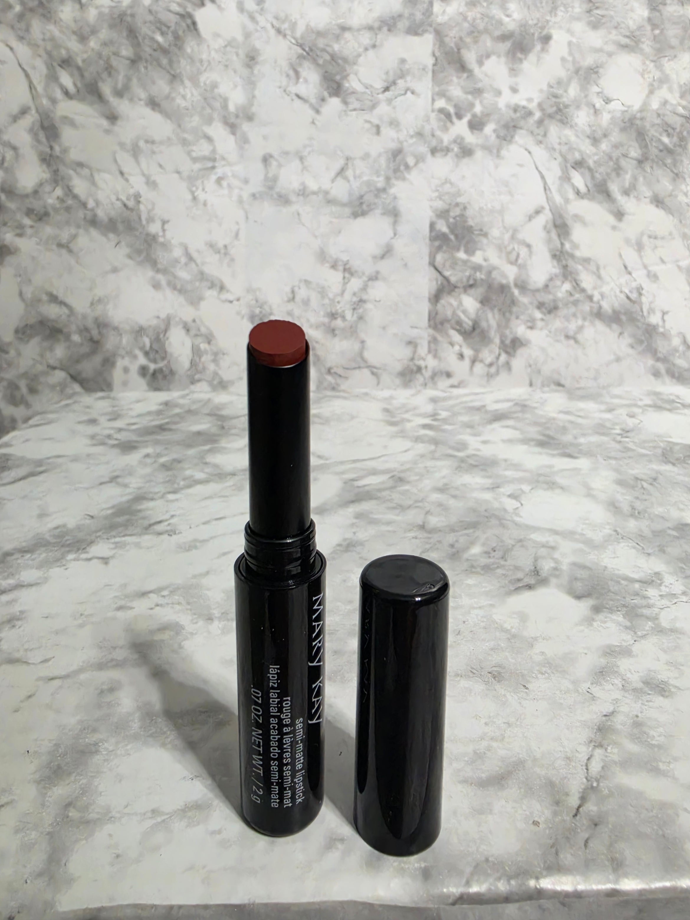 Mary Kay lipstick on a marble surface