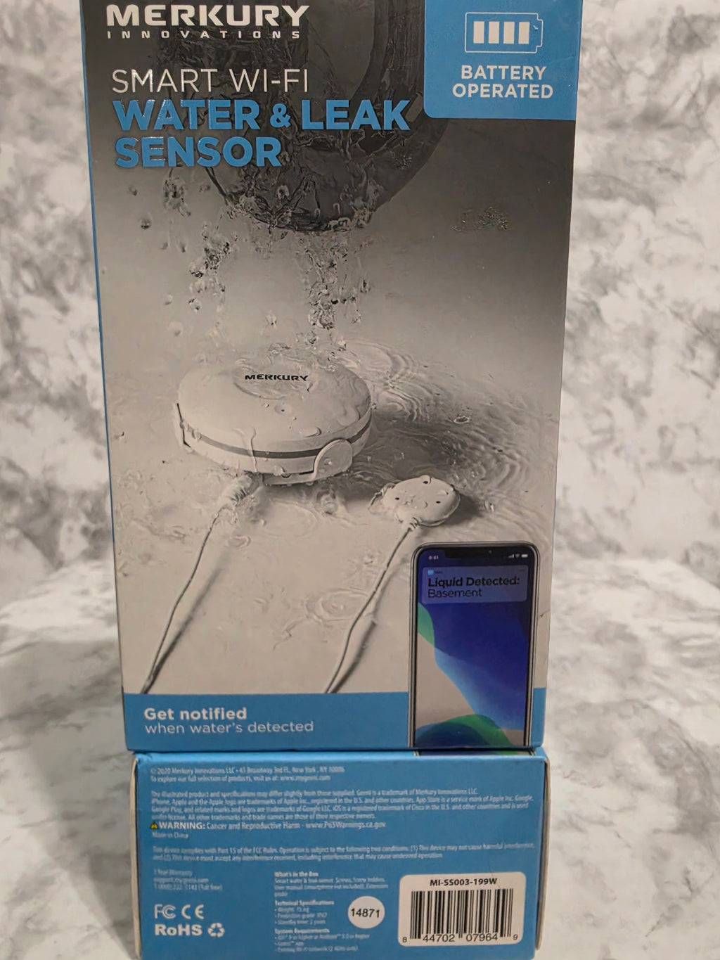 Merkury Innovations smart water and leak sensor packaging on a marble surface