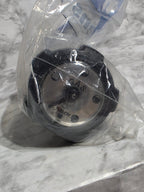 Metallic component in clear plastic packaging on a marble surface