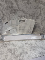 Metallic handle on a marble surface with a Delta brand leaflet.