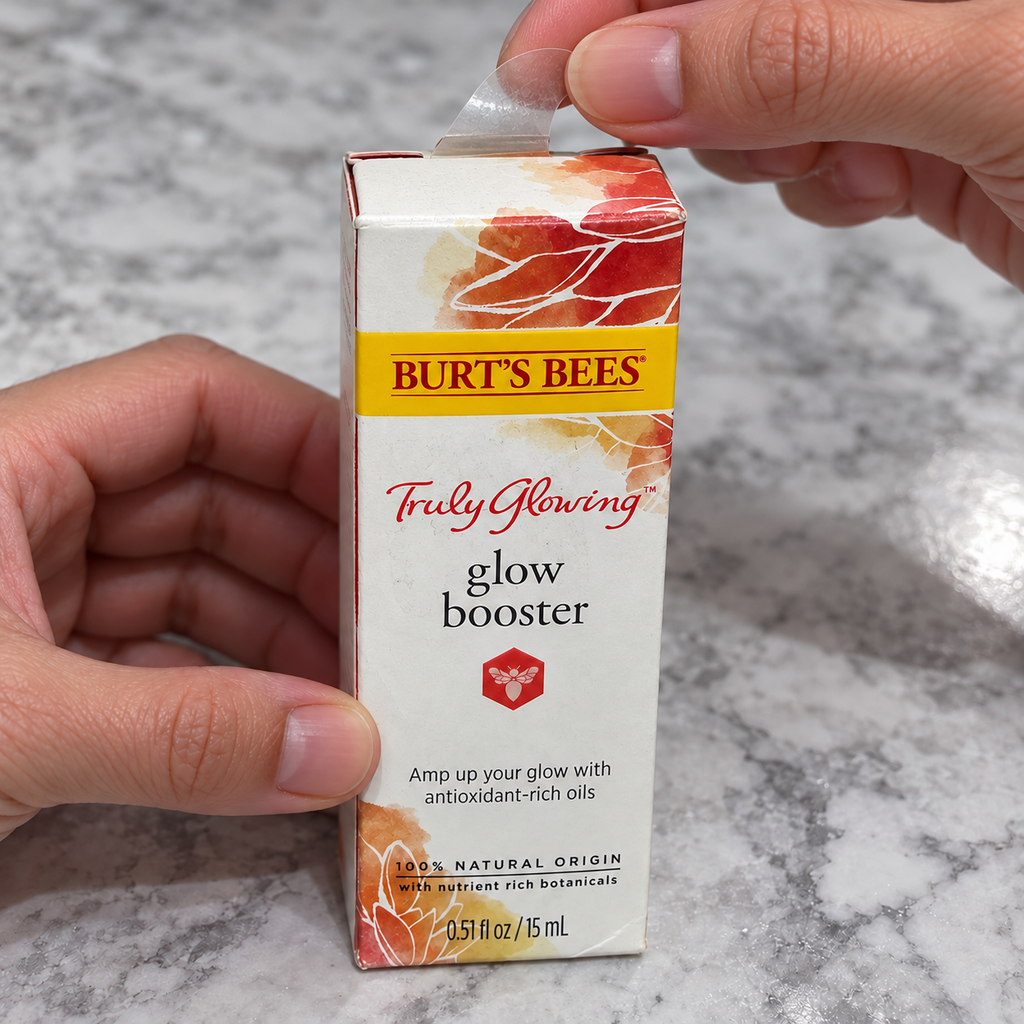 Adult hands opening Burt's Bees Truly Glowing Glow Booster carton, AI-assisted illustration