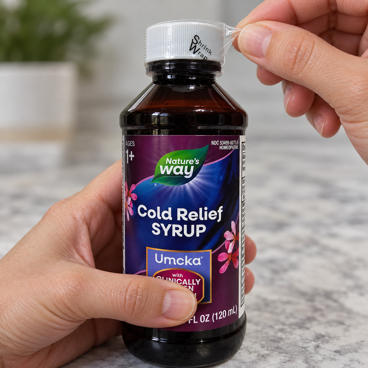 AI-generated illustration: adult fingertips peeling the clear outer cap wrap from a closed Nature's Way Umcka syrup bottle.