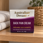 AI-generated lifestyle illustration: closed Australian Dream Back Pain Cream 4 oz carton on a home cabinet shelf; towel and basket are props, not included.