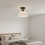 AI-generated lifestyle illustration: Avec Avery matte black and white metal-shade semi-flush light in a bedroom; bulb and room furnishings not included.