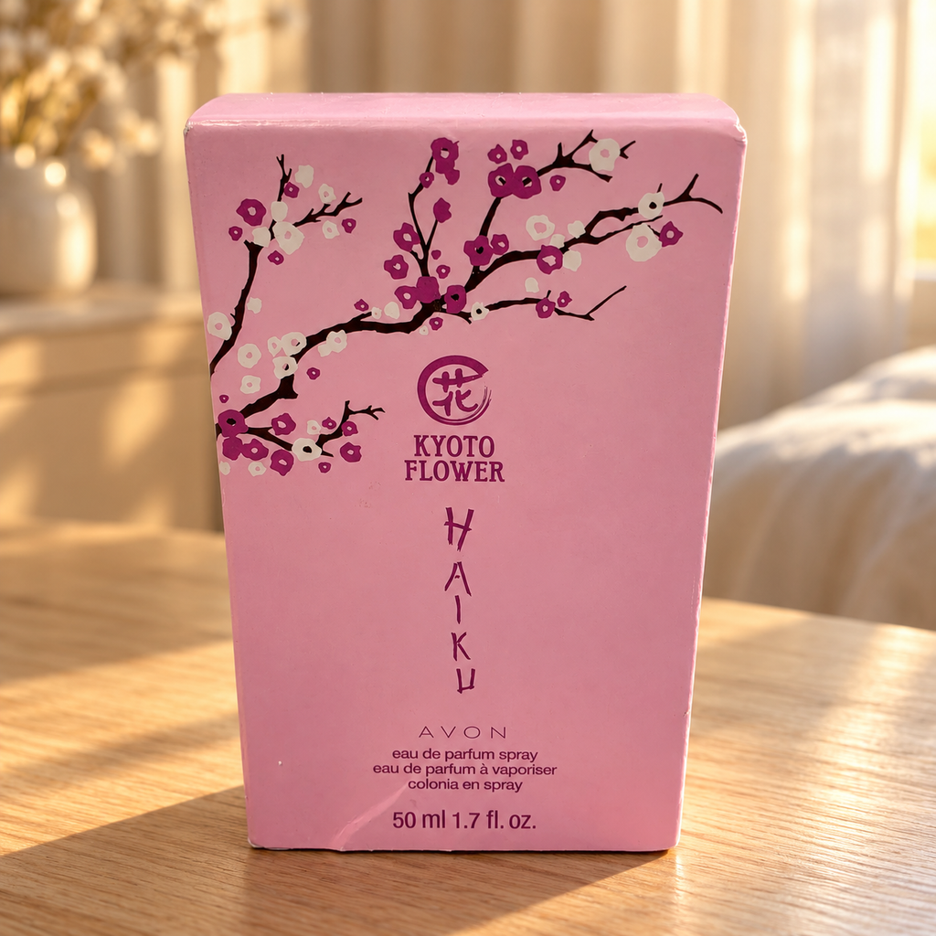 AI-generated lifestyle illustration: closed Avon Haiku Kyoto Flower 50 mL / 1.7 fl oz carton with visible creases on a dresser; furnishings and decorative props not included.