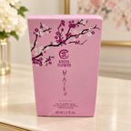 AI-generated lifestyle illustration: closed Avon Haiku Kyoto Flower 50 mL / 1.7 fl oz carton with visible creases on a console table; furnishings and decorative props not included.