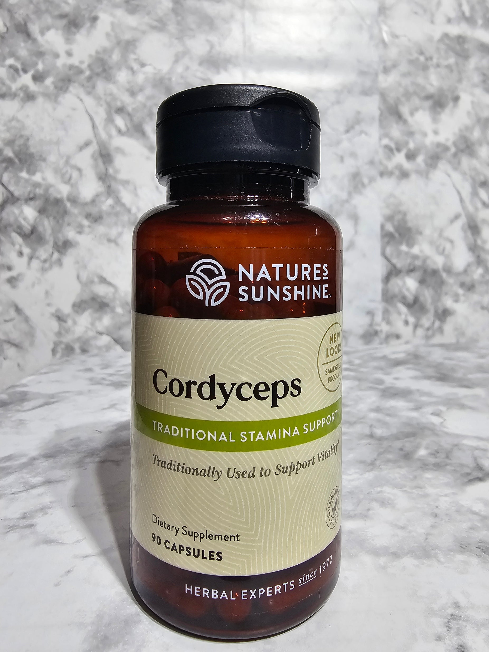 Nature's Sunshine Cordyceps supplement bottle on a marble surface