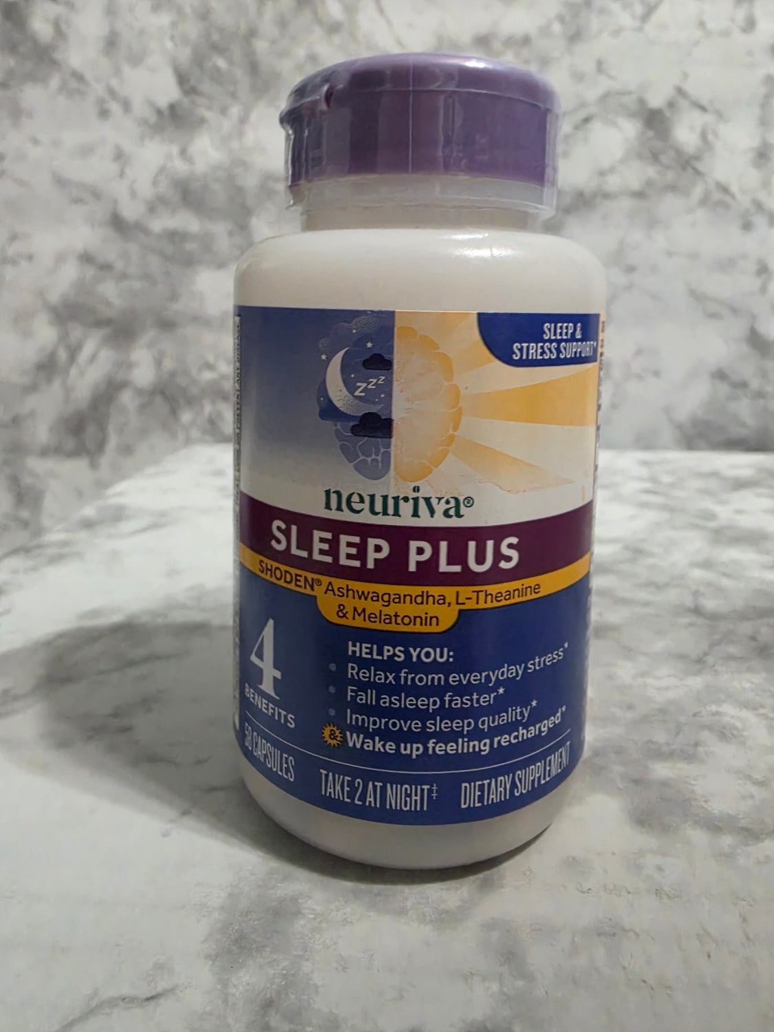 Neuriva Sleep Plus supplement bottle on a marble surface