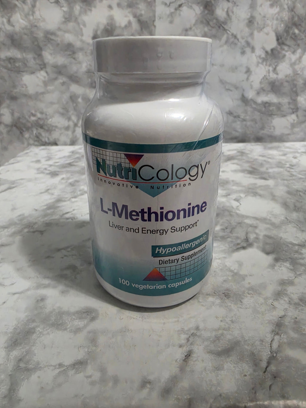 Nutricology L-Methionine supplement bottle on a marble surface